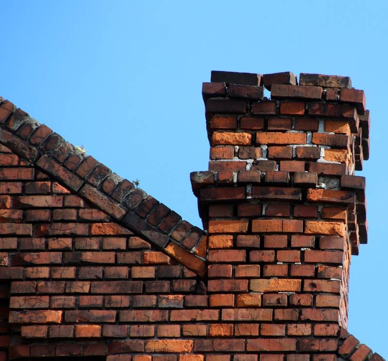 Signs Your Maybee Home Needs a Chimney Inspection Damaged chimney on an Maybee home showing cracks and missing mortar